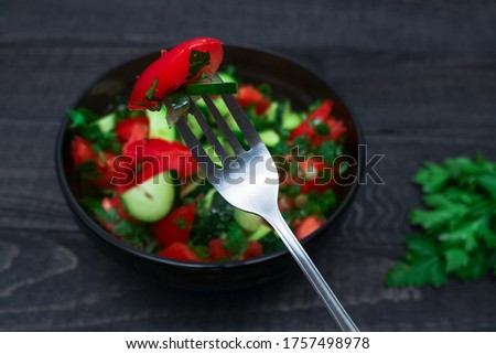 Tomato and cucumber salad with parsley. Vegan food. Diet menu. Top view. Flat lay. High quality photo