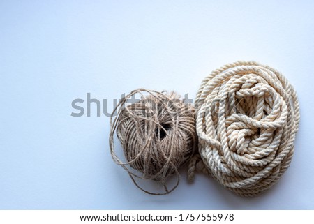 Two balls of rope on a white background.Skein of clothesline and twine
