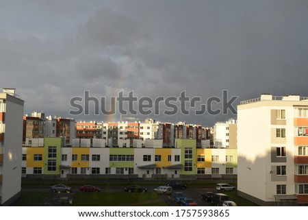 rainbow over buildings after rain