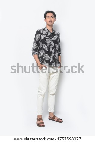 Full body Summer man casual wearing new stylish fern leaves printed long ,sleeves shirt with white pants and brown shoes,hands in pocket