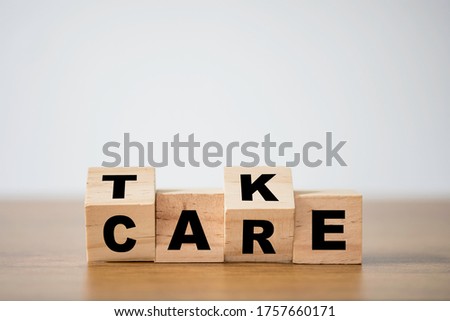 Flipping of take care yourself wording which print screen on wooden cubes blocks on table. Royalty-Free Stock Photo #1757660171