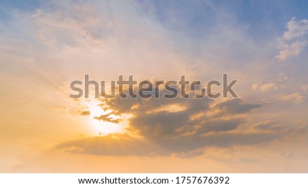 Colorful sunset in the sky, clouds and sun rays.