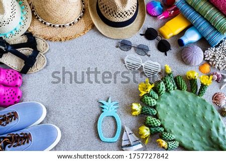 Seaside and beach items on the sand. Travel concept with top view. 