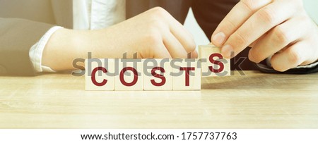 Man made word Costs with wood blocks
