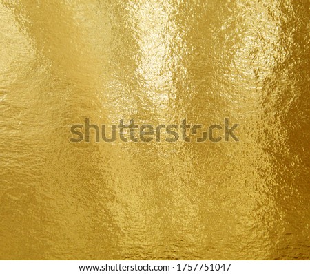 Gold foil texture background with highlights and uneven surface Royalty-Free Stock Photo #1757751047
