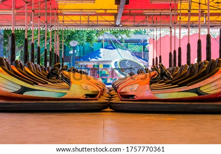Dusty colored  electric bumper cars or dodgem cars parked. Royalty-Free Stock Photo #1757770361