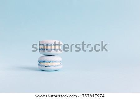 Tasty french macaroons on a light blue pastel background.  Place for text.