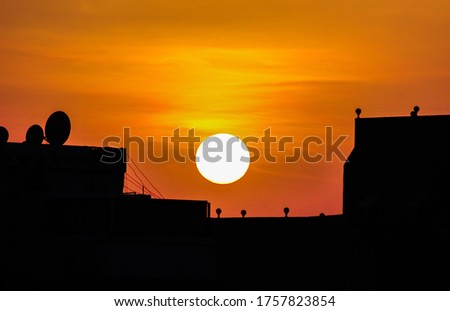 Beautiful sunset on top of building and colorful sky.