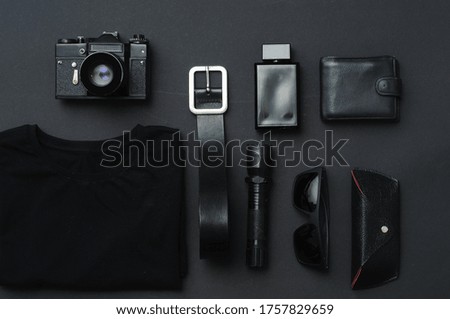 Flat lay composition with male accessories on black background