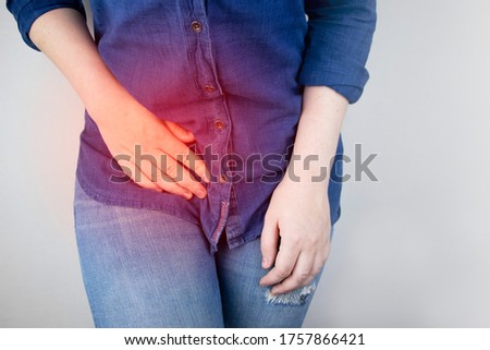 A woman suffers from pain in the appendix. Acute appendicitis, Crohn's disease, or inflammatory bowel disease. Surgeon examination and preparation for laparoscopic appendectomy Royalty-Free Stock Photo #1757866421