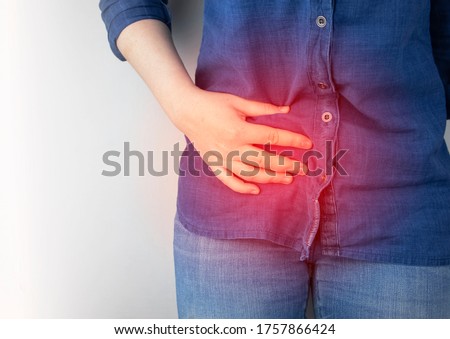 A woman suffers from pain in the appendix. Acute appendicitis, Crohn's disease, or inflammatory bowel disease. Surgeon examination and preparation for laparoscopic appendectomy Royalty-Free Stock Photo #1757866424
