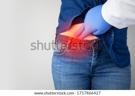 A woman suffers from pain in the appendix. Acute appendicitis, Crohn's disease, or inflammatory bowel disease. Surgeon examination and preparation for laparoscopic appendectomy Royalty-Free Stock Photo #1757866427