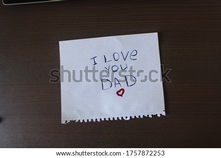 I love you Dad! Handwritten message on a graph paper! Top view on work space.