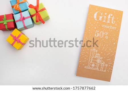 Top view of presents and gift voucher with 50 percents sign on white background