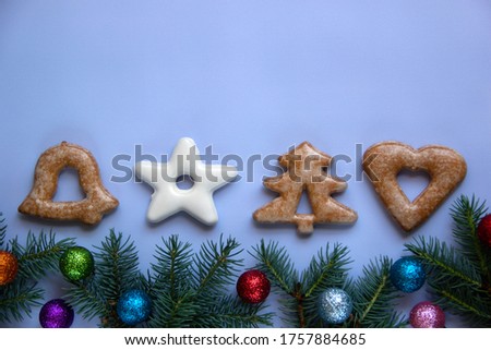 Natural composition with Christmas tree branches, Christmas balls and cookies. Minimal Christmas background flat lay. Holiday concept. Top view, copy space.