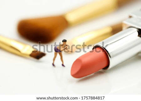 Miniature people : beautiful woman and Makeup products with cosmetic