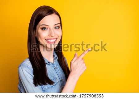 Turned photo of positive cheerful girl promoter point index finger copyspace indicate ads promo recommend suggest select wear good look clothes isolated shine color background