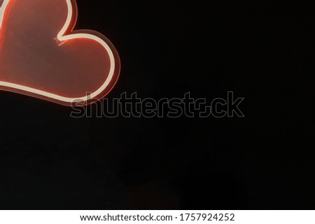 dark wood background with neon pink LED heart
