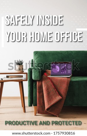 green sofa, blanket and laptop with charts and graphs near safely inside your home office lettering, wooden coffee table with plant and books