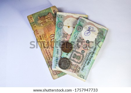 image of old Indian currency notes and coins on white background.