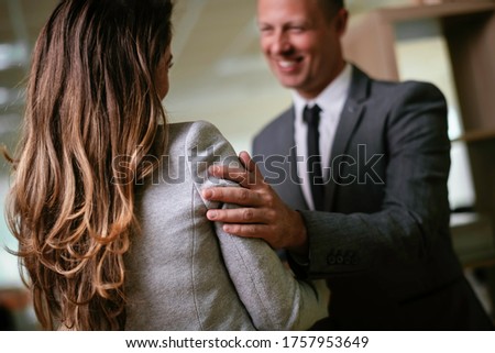 Businessman and businesswoman in office. Young woman and man flirting in office.