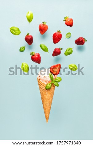 Flying strawberry and basil ice cream cone in motion