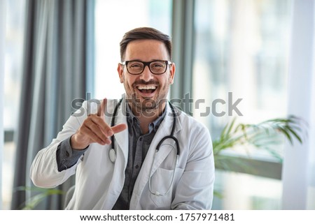 Video Chat with Patient by Doctor. Online Video Chat with Patient by Male Doctor, Camera View. Male doctor speaks to camera during web conference 