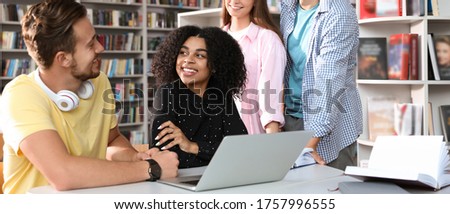 Group of young students at table in library. Banner design