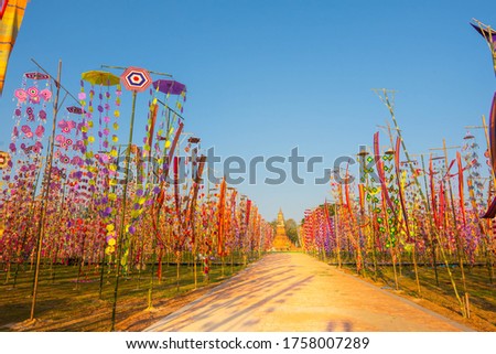 Polygon color swatch made from multicolored thread tied in bunches on bamboo poles To decorate in the Buddhist festival
