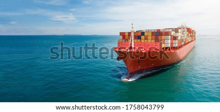 Aerial in front of cargo ship carrying container and running with tug boat for export cargo . Royalty-Free Stock Photo #1758043799