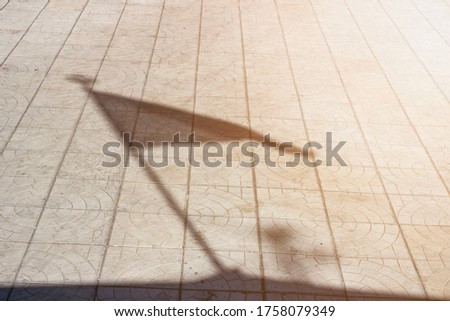 shadow on the flag on concrete paving
