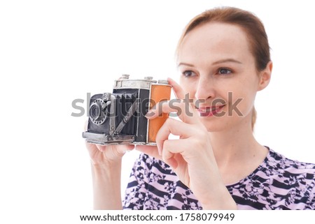 Young woman in casual wear using camera