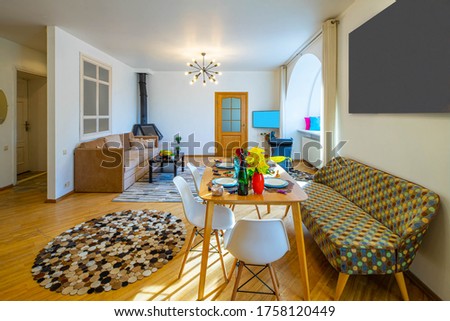 Modern interior of living room in luxury apartment. Cozy sofas. Table and chairs.