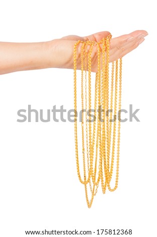 golden necklace in left hand isolated on white