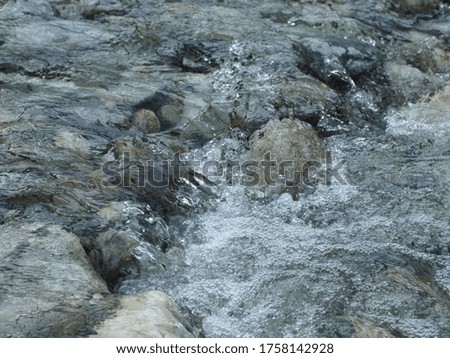 water running over stones in a Creek near panda habitat.