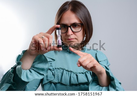 Young business woman holding hourglass.Time concept. woman holding hour glass sand timer, aging process concept.