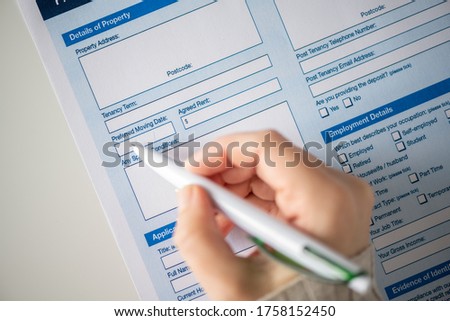 Woman customer filling property reservation form, preferred moving date. Rental agreement apartment, house. Close up. Selective focus. Royalty-Free Stock Photo #1758152450