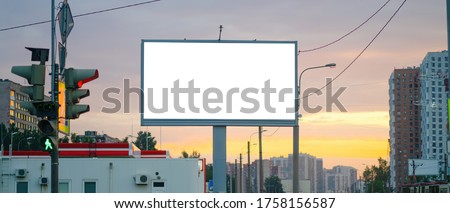 Advertising billboard advertising large horizontal screen MOCKUP for advertising. Against the background of the sunset, glowing.