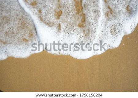 Bubbles of sea waves on the beach with clear sand on holiday and giving a relaxing feeling, Asian beach.
