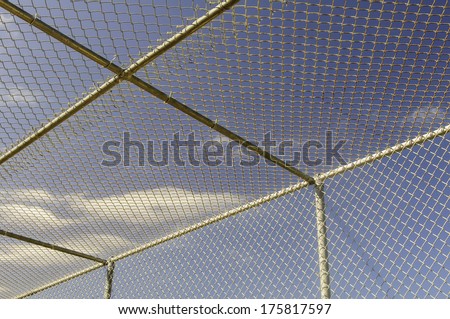 Part of batting cage by baseball field Royalty-Free Stock Photo #175817597