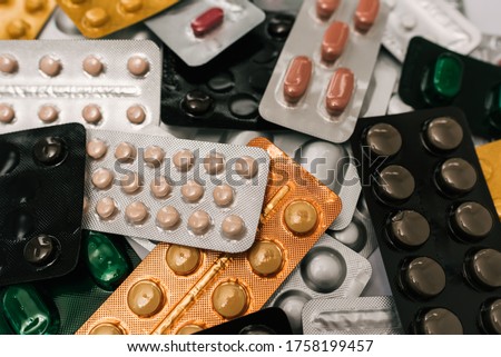 Stock photo of a bunch of tablets in colored blister packaging. There is nobody on the picture.