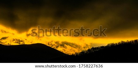 Beautiful colorful sunset sky above hill tops of the Velebit mountain