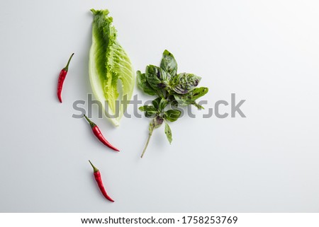 Salad and Basil on a white background. Minimum concept