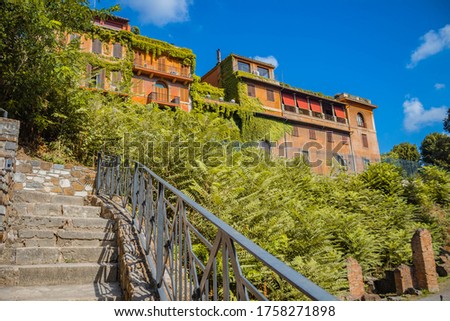 Stairs in Rome with a orange building iin the background Royalty-Free Stock Photo #1758271898