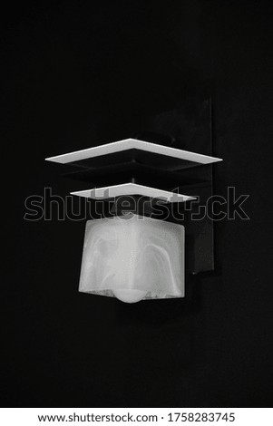 Beautiful wooden geometric modern lamp interior modern decor isolated on a dark background.
