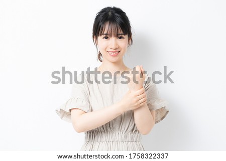 Young woman showing wrists shot in studio