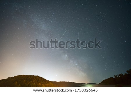Universe with Summer Milky Way, Jupiter, Saturn planets and satellite light in the night sky.