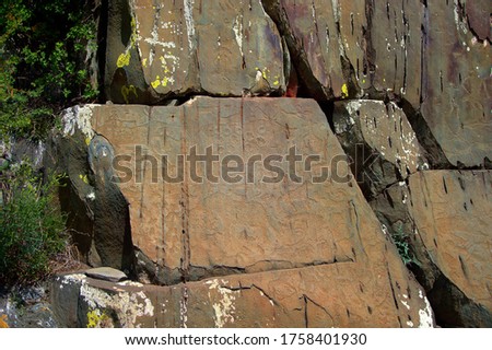 Rock massif with drawings of ancient people, petroglyphs on a stone. Archaeological complex Kalbak-Tash, Gorny Altai, Siberia, Russia.