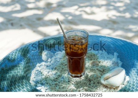 A glass of cold cocktail on a table on the beach in a restaurant. Maldives