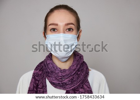 Girl in medical mask on white background empty space